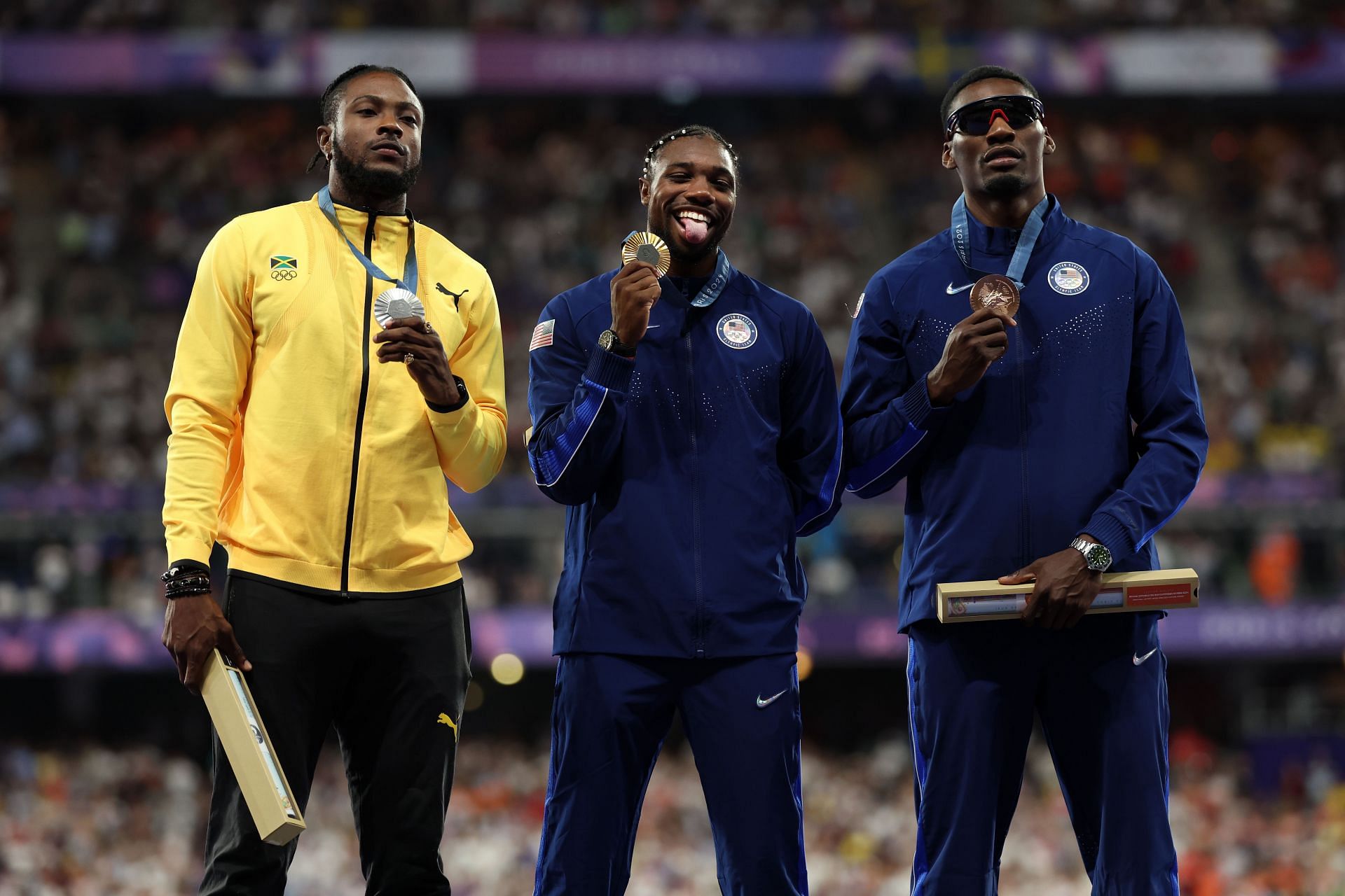 Noah Lyles, Kishane Thompson, and Fred Kerley on the podium during the Men's 100m medal ceremony at Paris Games 2024 - Source: Getty